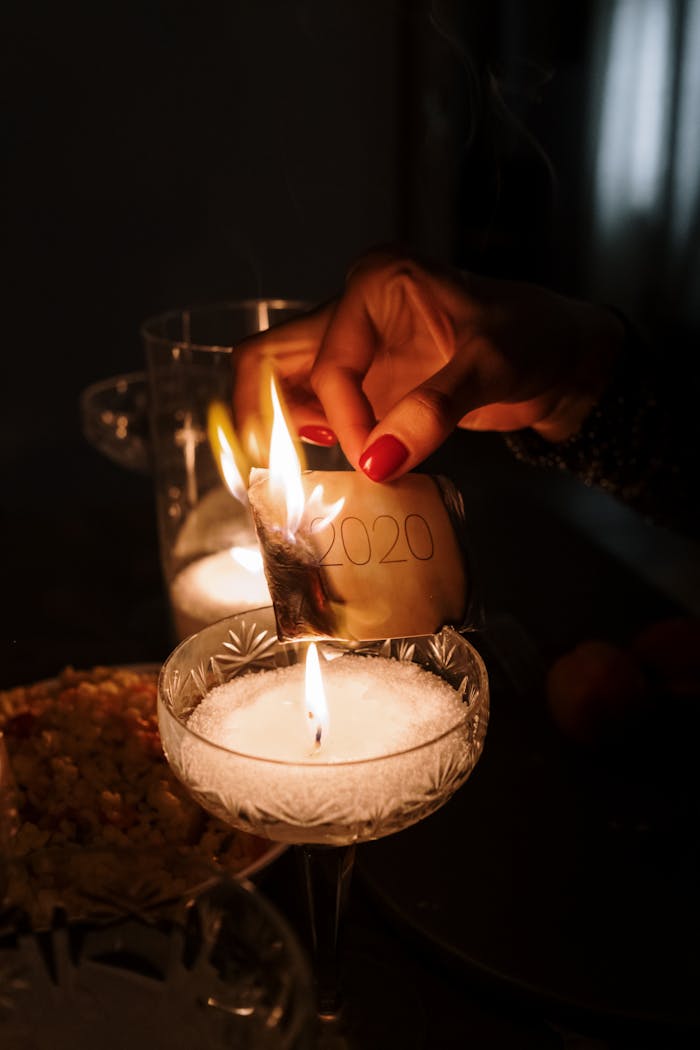 An intimate candlelight dinner scene with a symbolic burning of 2020 in a cozy home setting.